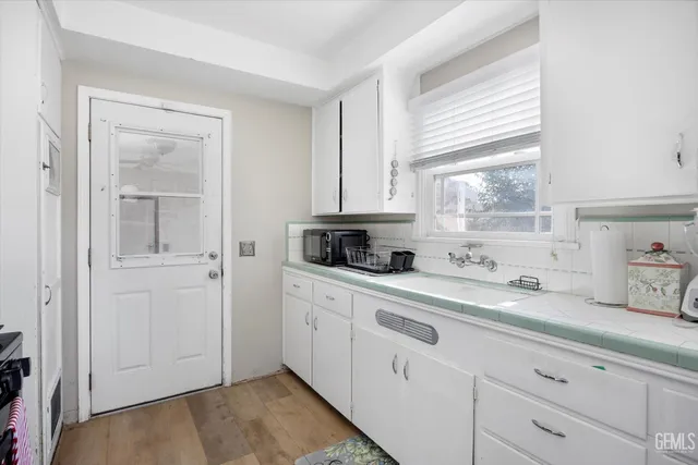 a kitchen with stainless steel appliances sink refrigerator and window