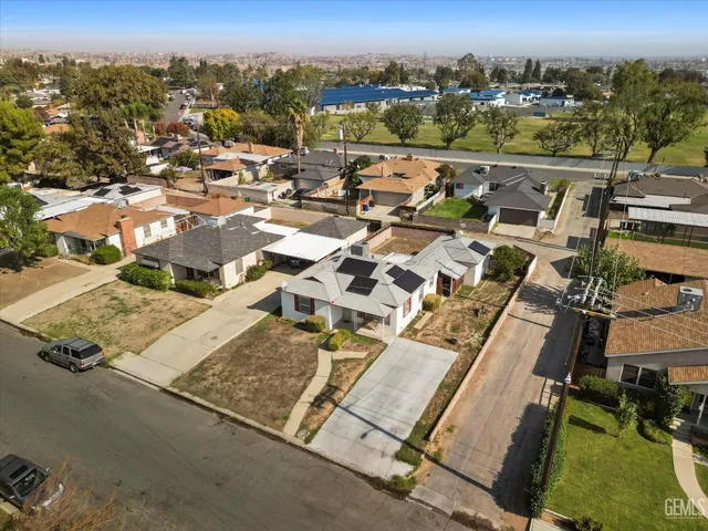 an aerial view of residential houses with city view