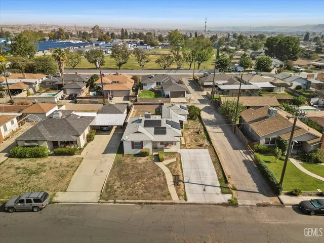 an aerial view of multiple houses with yard