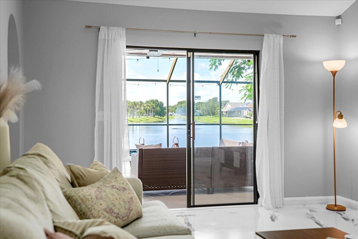 1901 Jacques Drive Melbourne, FL 32940 - Photo 13 of 43 a living room with furniture and a floor to ceiling window