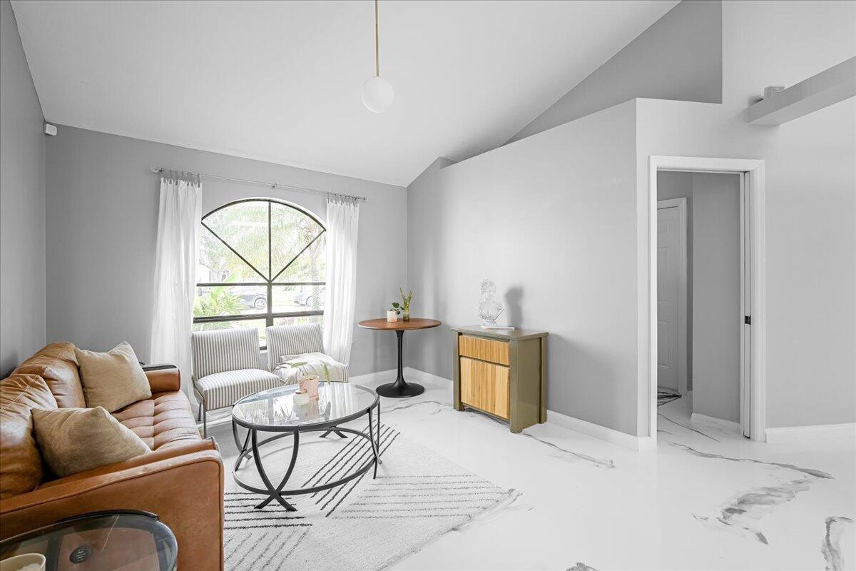 1901 Jacques Drive Melbourne, FL 32940 - Photo 16 of 43 a living room with furniture a table and a large window