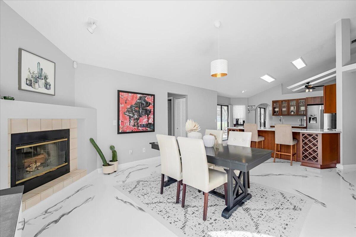 1901 Jacques Drive Melbourne, FL 32940 - Photo 24 of 43 a living room with furniture a fireplace and kitchen view