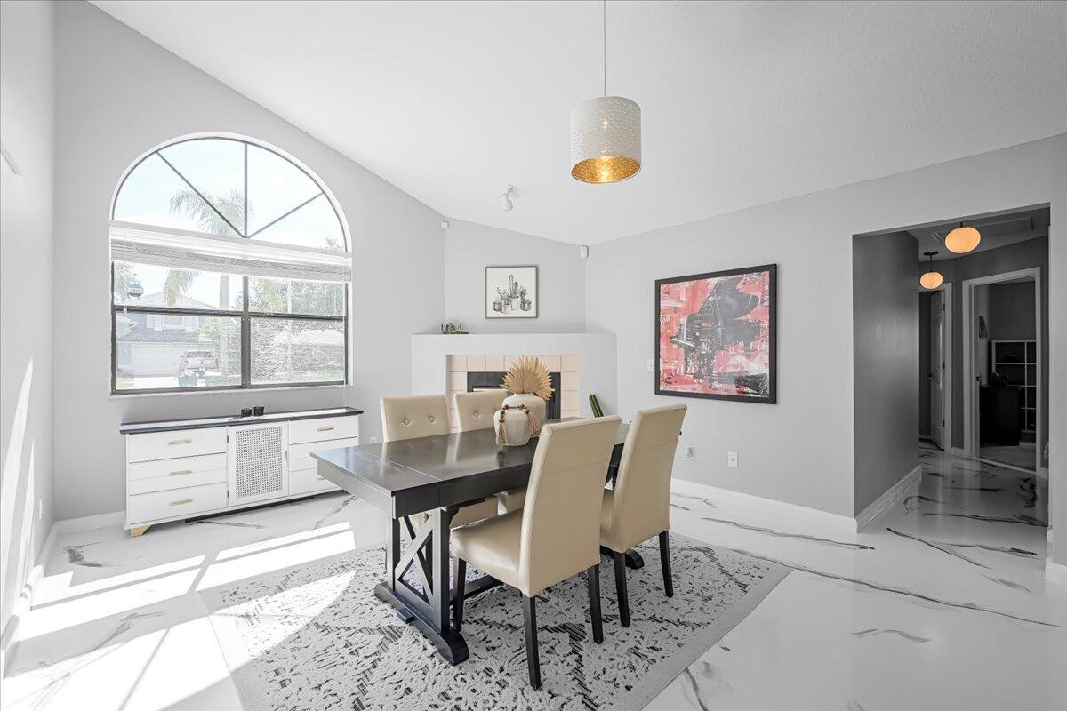 1901 Jacques Drive Melbourne, FL 32940 - Photo 27 of 43 a dining room with wooden floor and a window