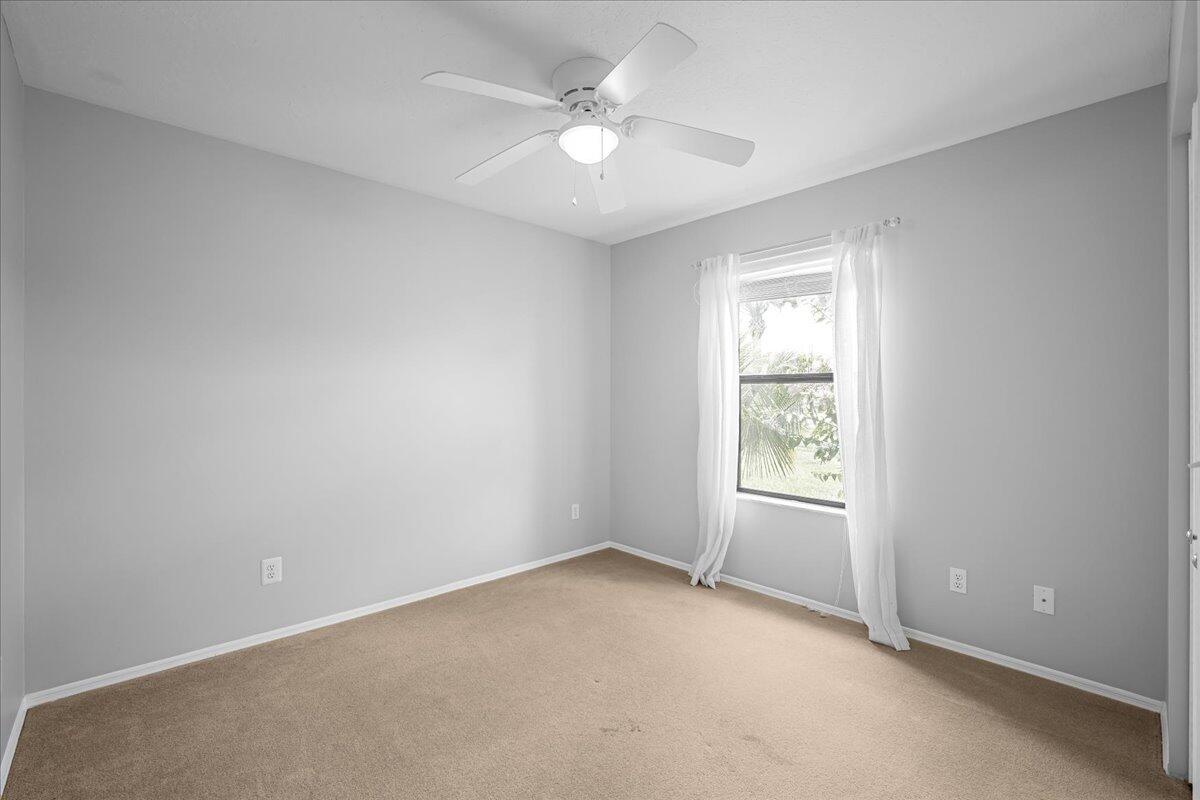 1901 Jacques Drive Melbourne, FL 32940 - Photo 29 of 43 an empty room with windows and ceiling fan