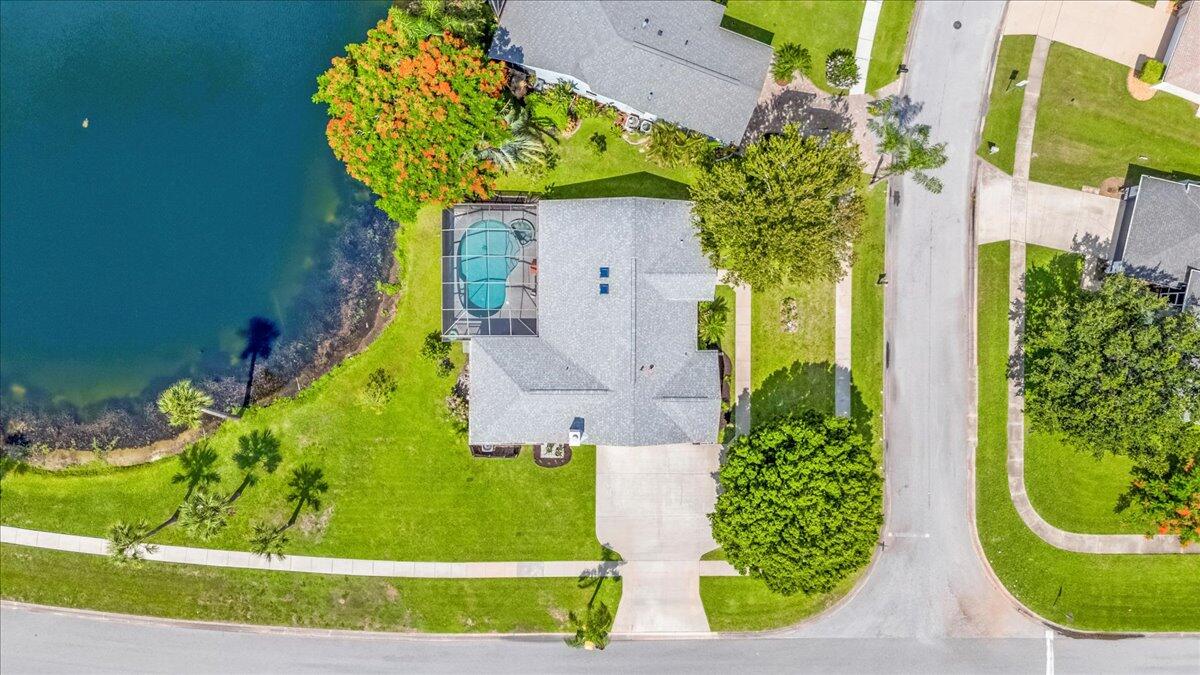 1901 Jacques Drive Melbourne, FL 32940 - Photo 3 of 43 an aerial view of a house with a yard and large trees