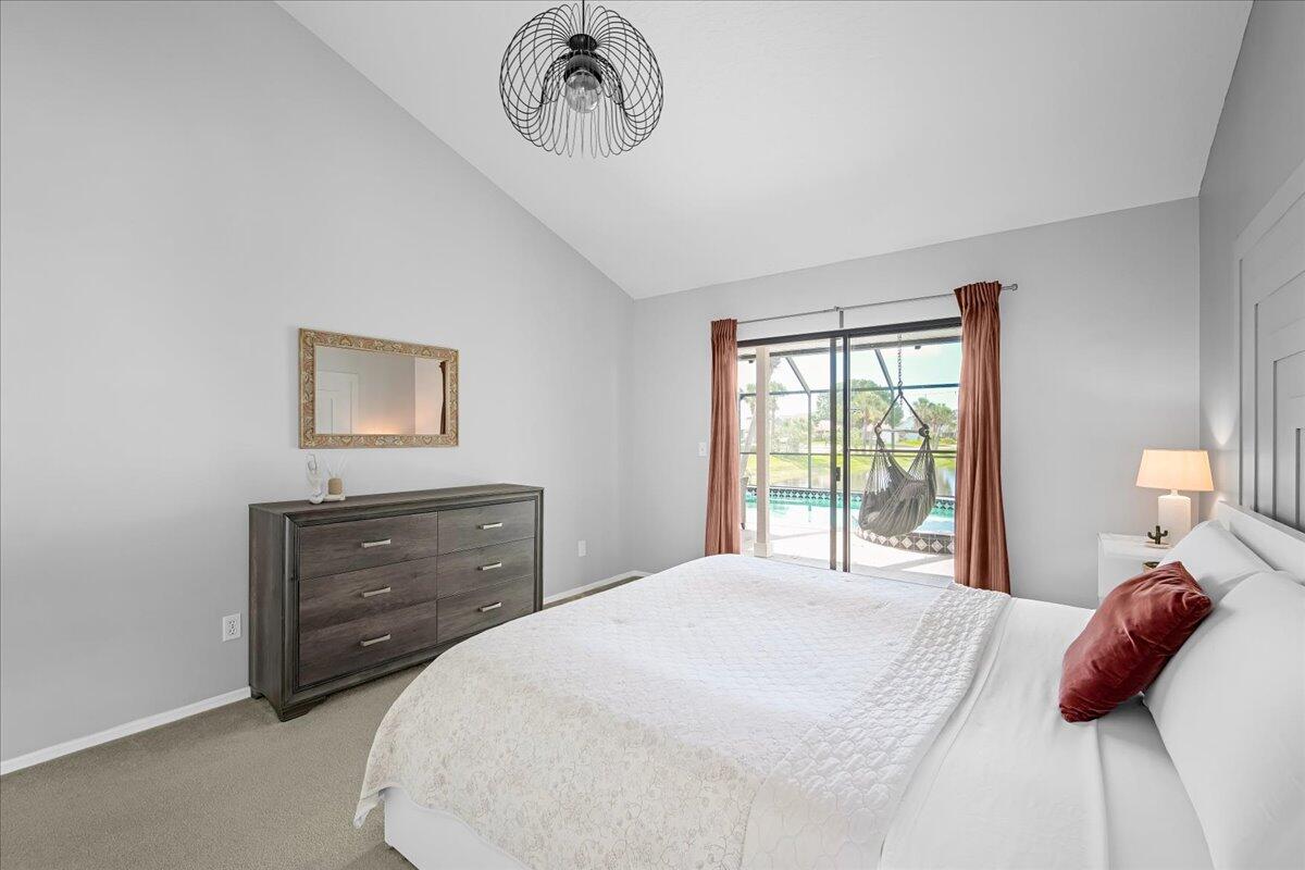 1901 Jacques Drive Melbourne, FL 32940 - Photo 37 of 43 a bedroom with a bed and a chandelier