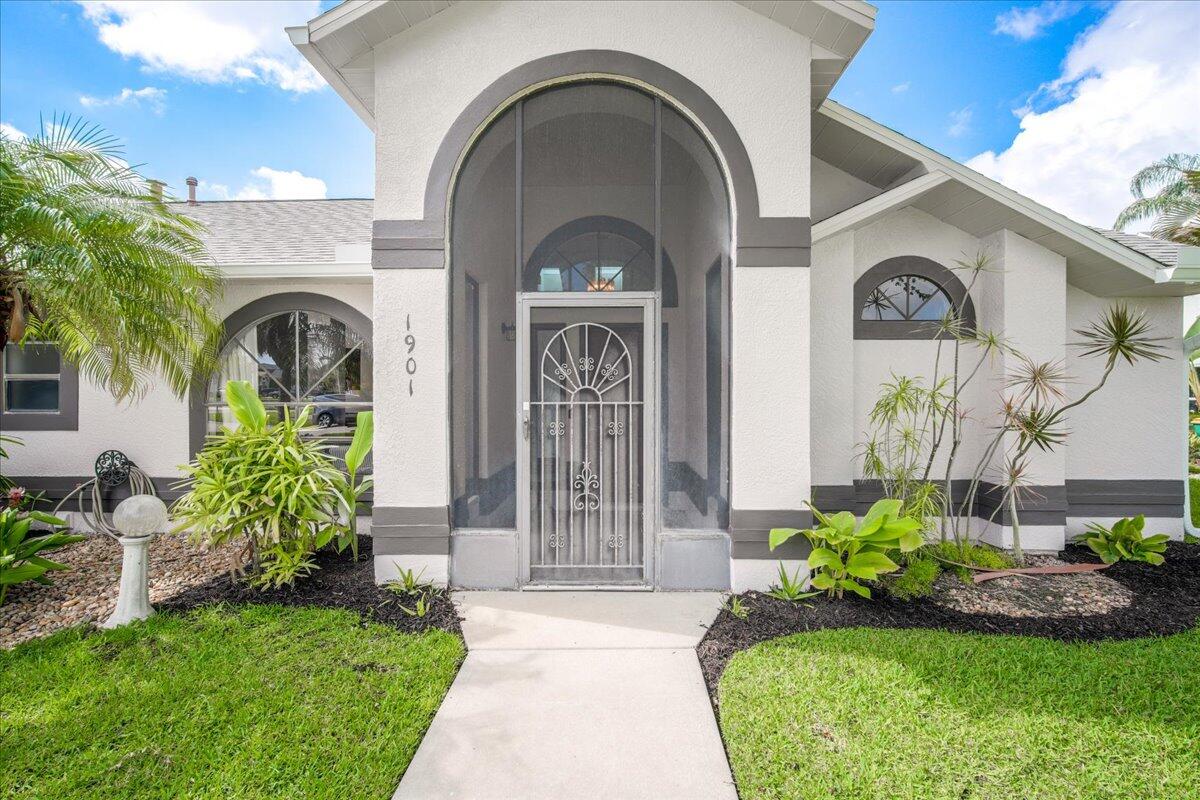 1901 Jacques Drive Melbourne, FL 32940 - Photo 9 of 43 a front view of a house with a garden