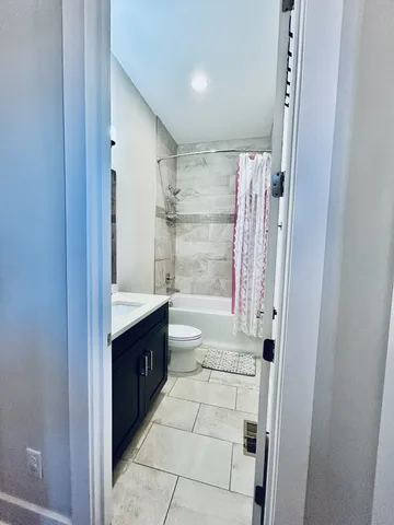 a kitchen with a dining table chairs refrigerator and cabinets