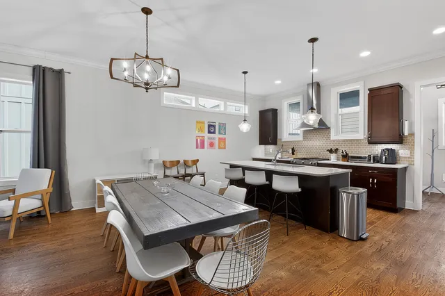 a kitchen with stainless steel appliances granite countertop a sink a stove and a refrigerator