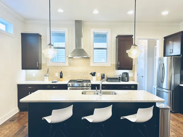 a spacious bedroom with a bed a couch and a window