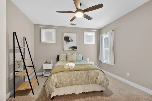 a bedroom with a bed and a chandelier