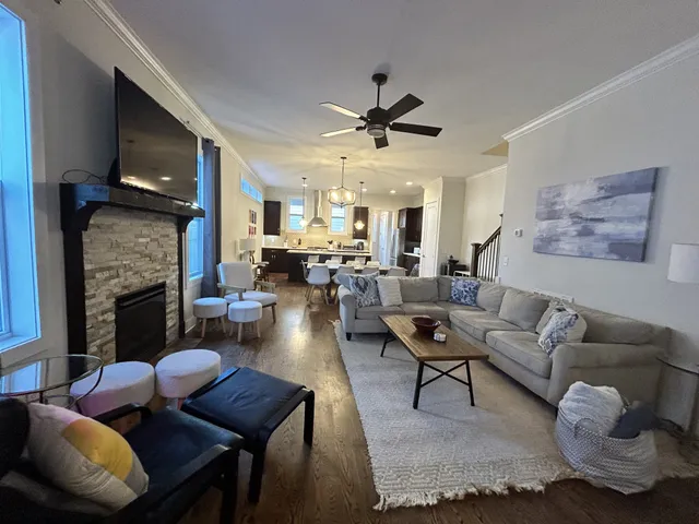 a living room with furniture rug and a lamp