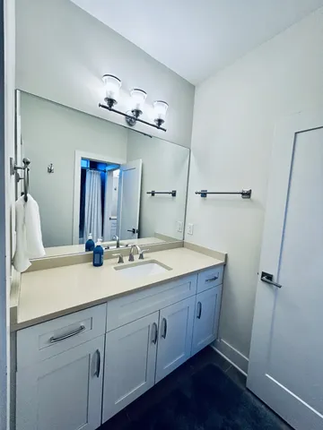 a bedroom with a large bed and chandelier