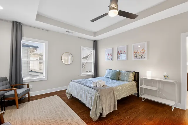 a bathroom with a toilet and a chair