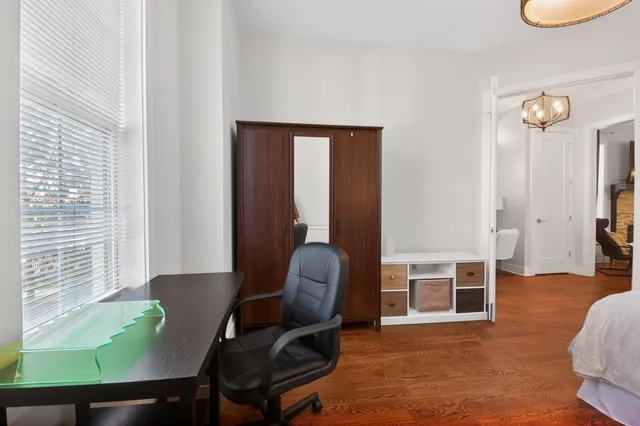 a view of a dining room with furniture wooden floor and chandelier