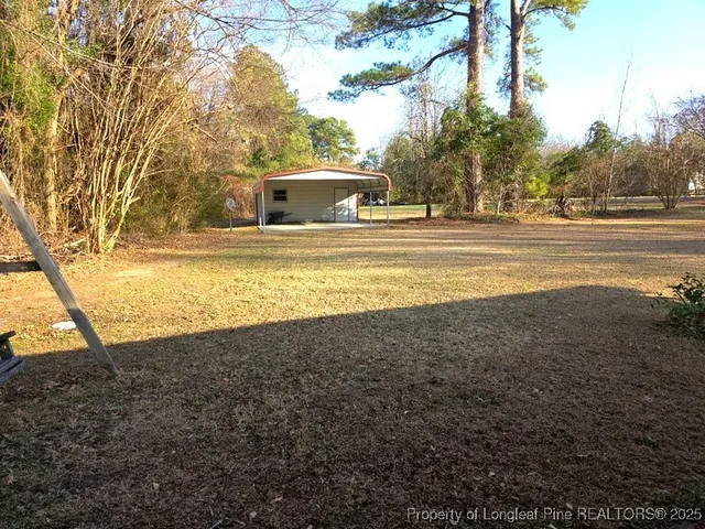 a backyard of a house with barbeque oven