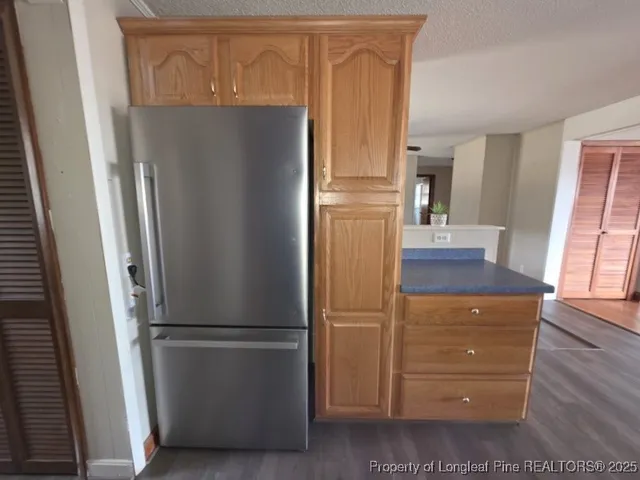 a view of a kitchen with refrigerator and cabinet