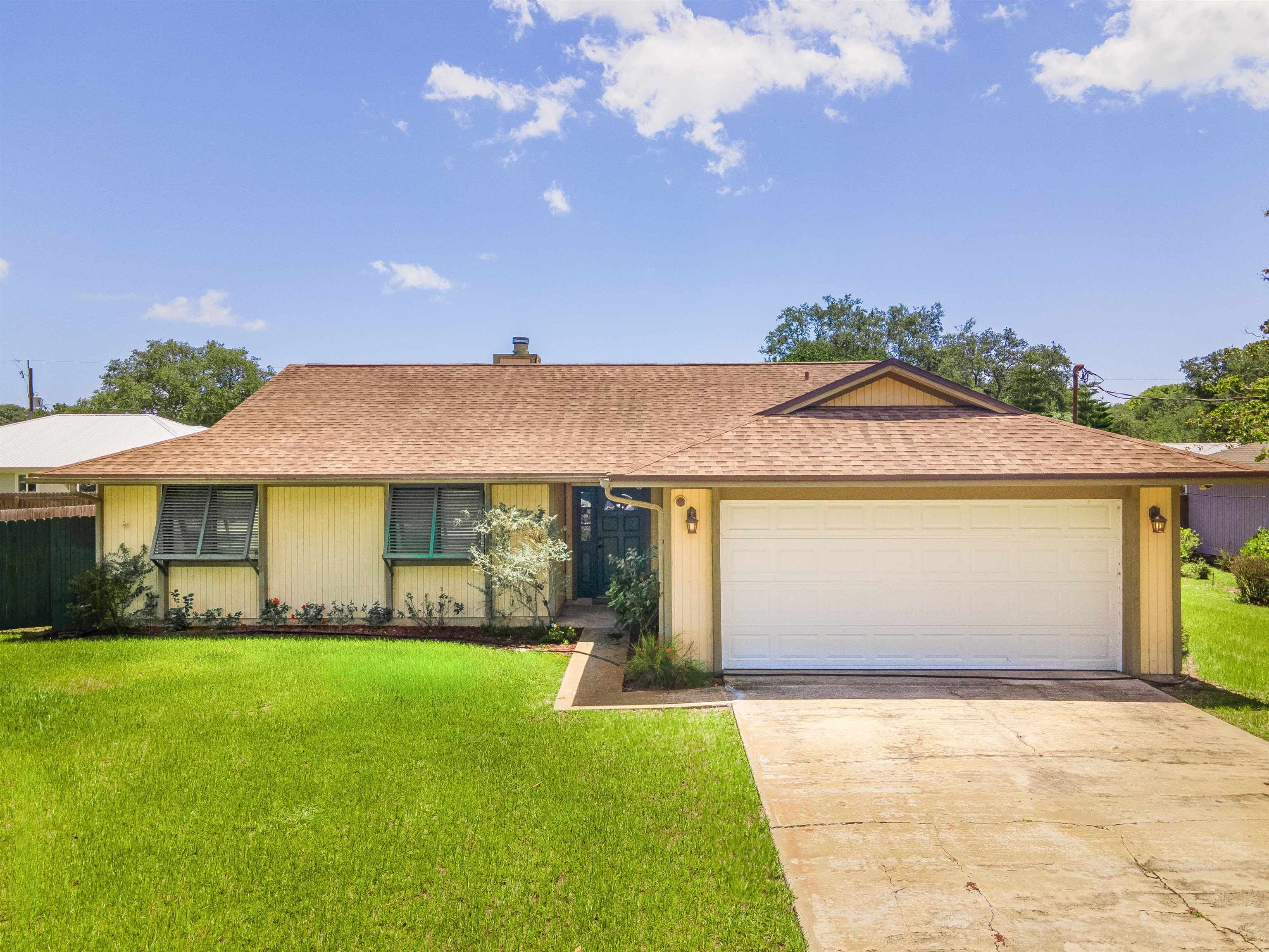 a front view of a house with garden