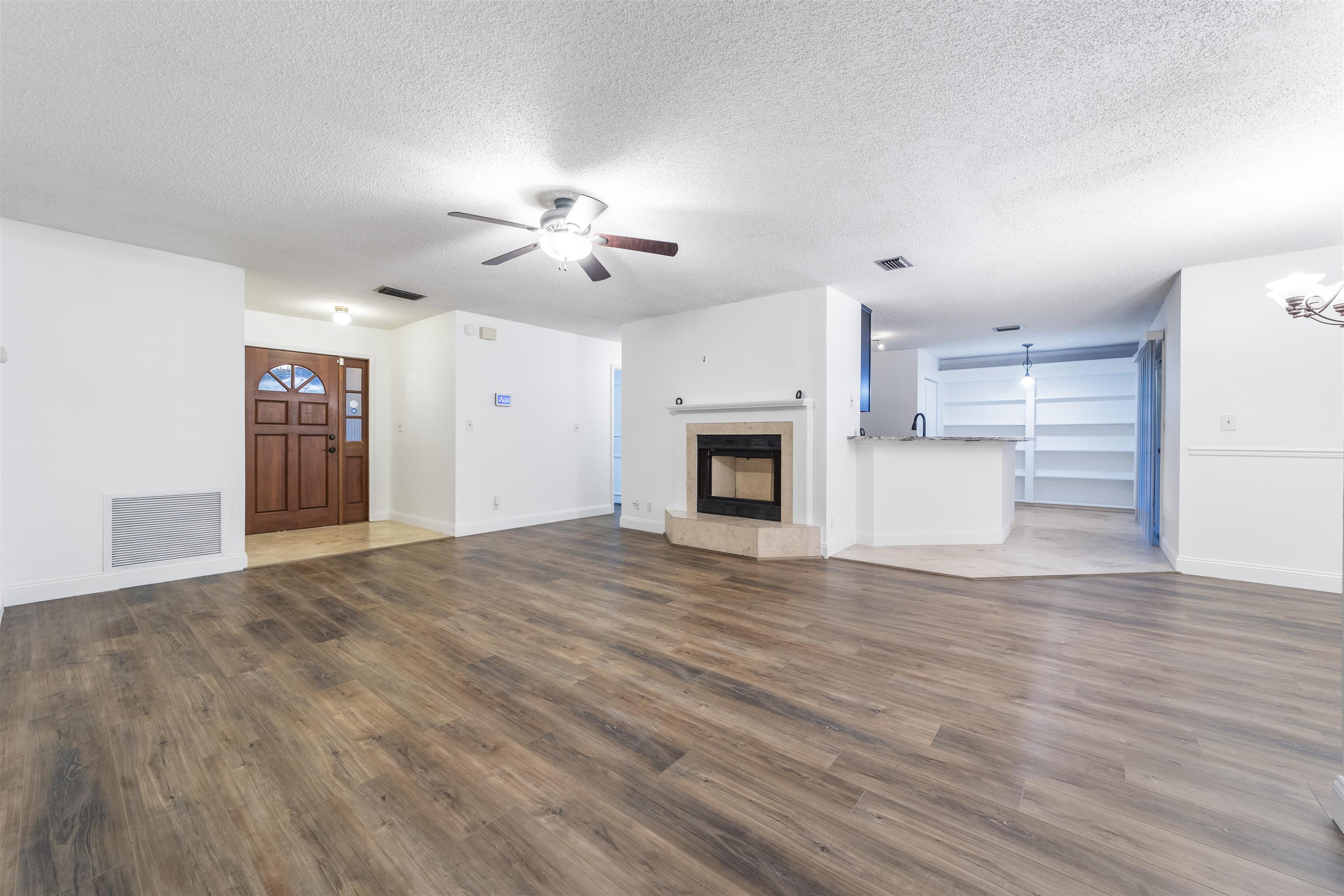 111 Lobelia Road St. Augustine, FL 32086 - Photo 11 of 46 a view of empty room with a fireplace and wooden floor