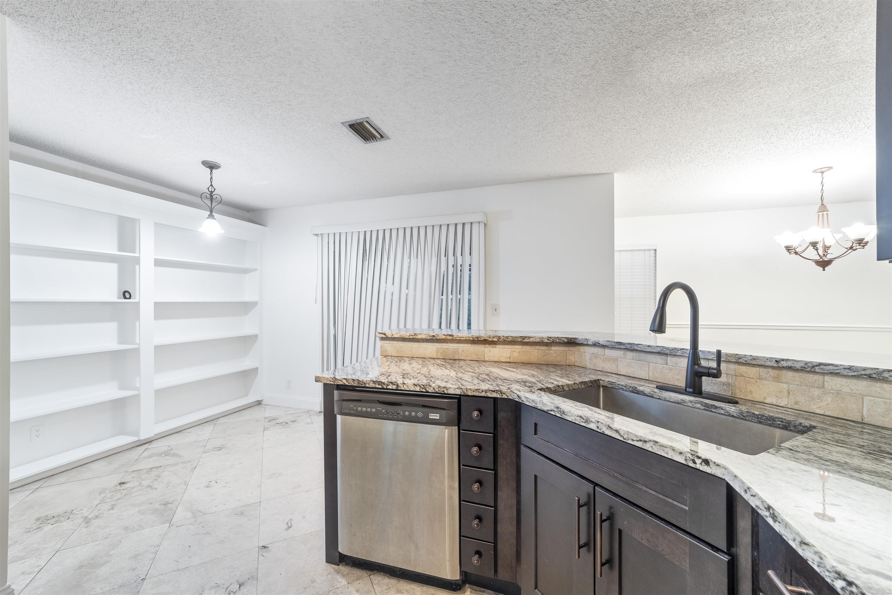 111 Lobelia Road St. Augustine, FL 32086 - Photo 20 of 46 a kitchen with granite countertop a stove and a sink