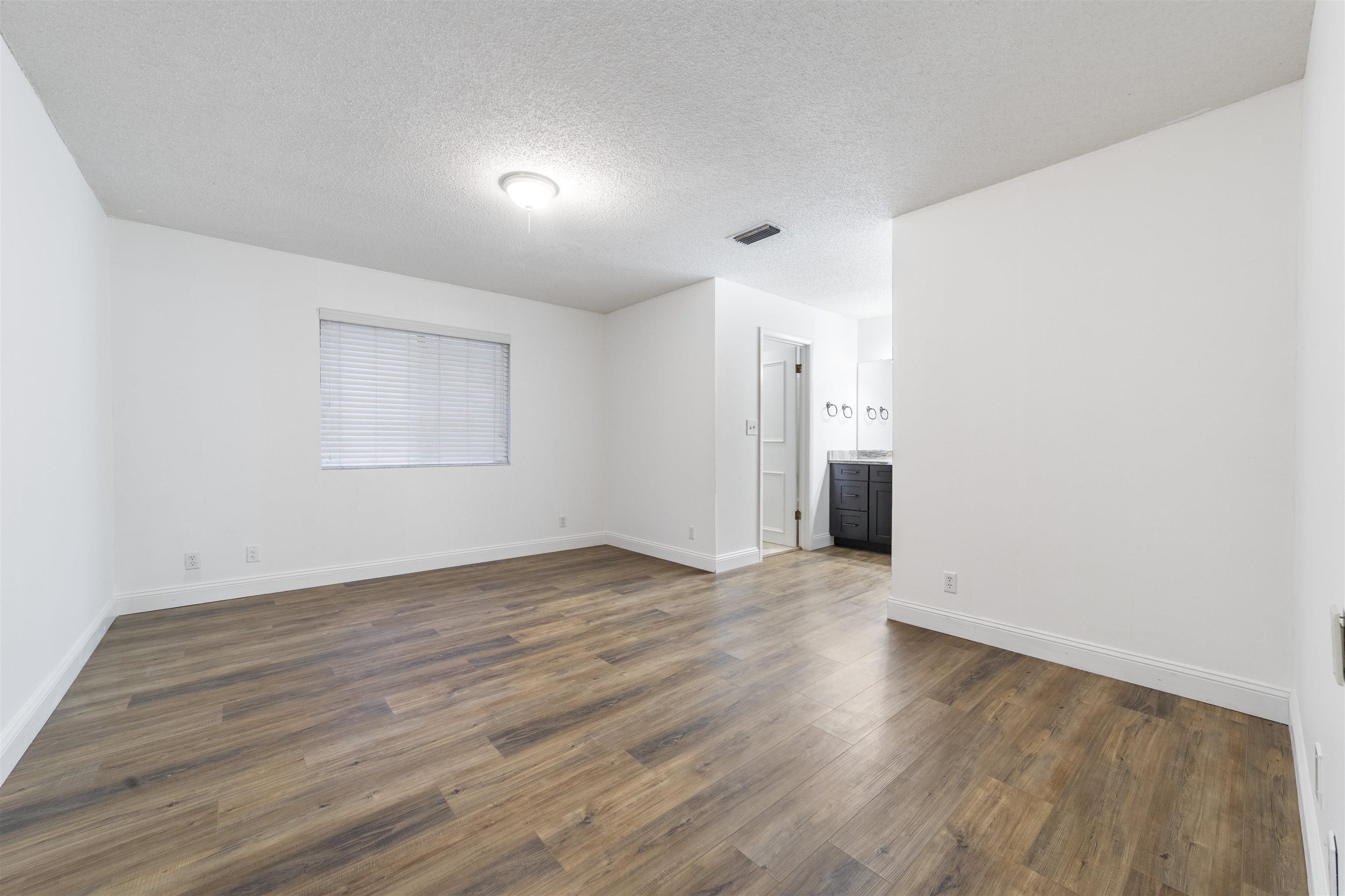 111 Lobelia Road St. Augustine, FL 32086 - Photo 23 of 46 an empty room with wooden floor and windows