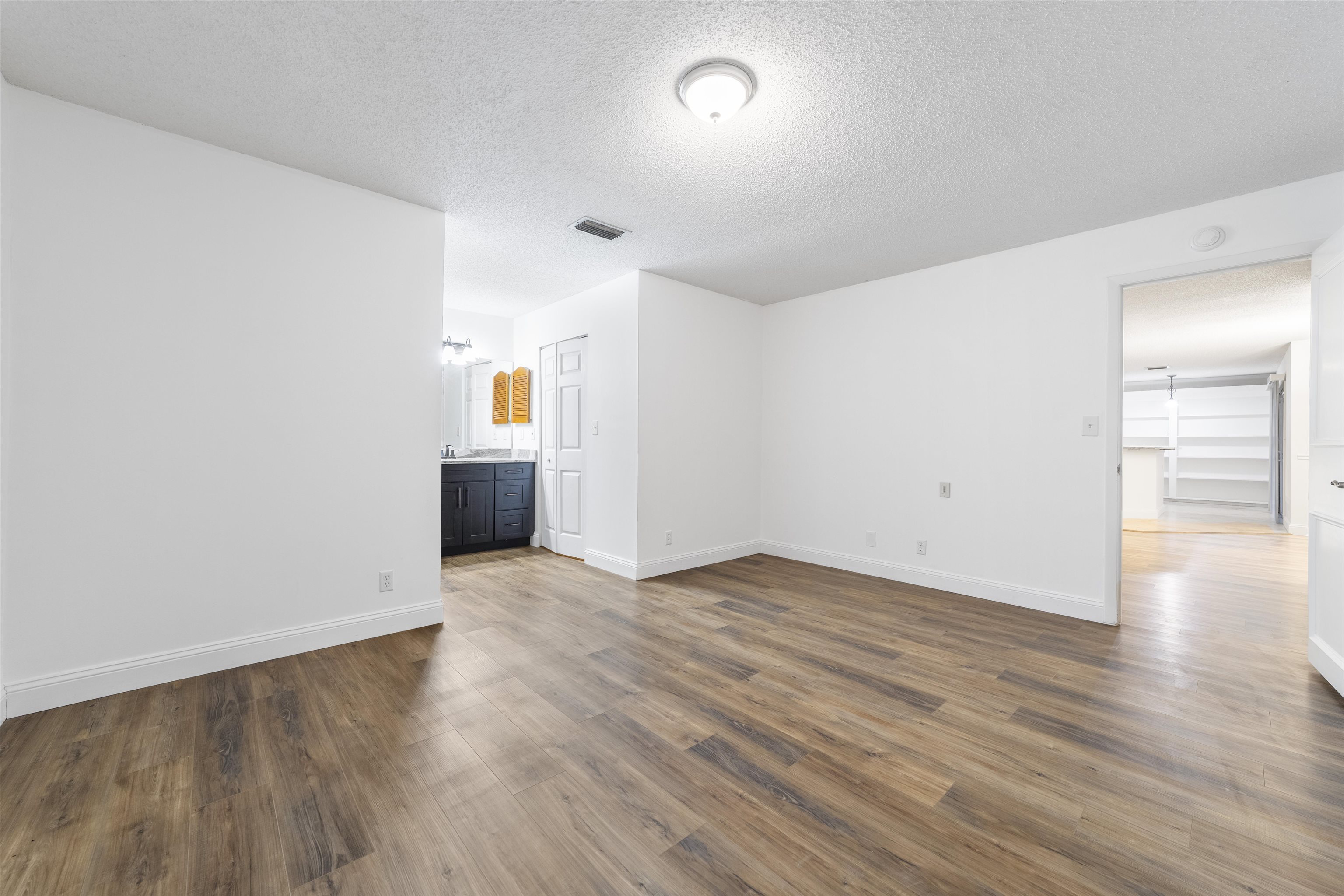 111 Lobelia Road St. Augustine, FL 32086 - Photo 24 of 46 an empty room with wooden floor and windows