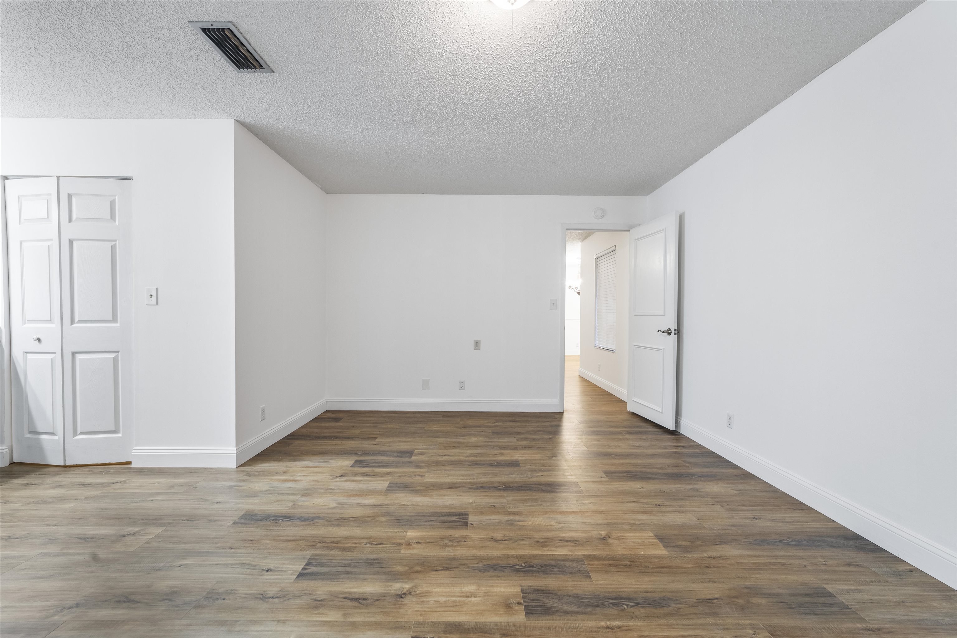 111 Lobelia Road St. Augustine, FL 32086 - Photo 27 of 46 a view of an empty room with wooden floor