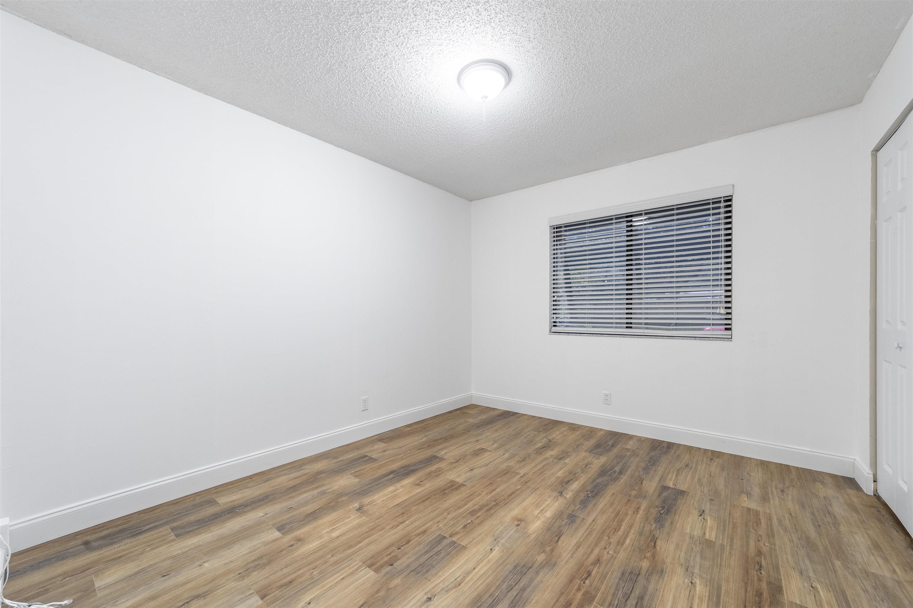 111 Lobelia Road St. Augustine, FL 32086 - Photo 32 of 46 an empty room with wooden floor and windows