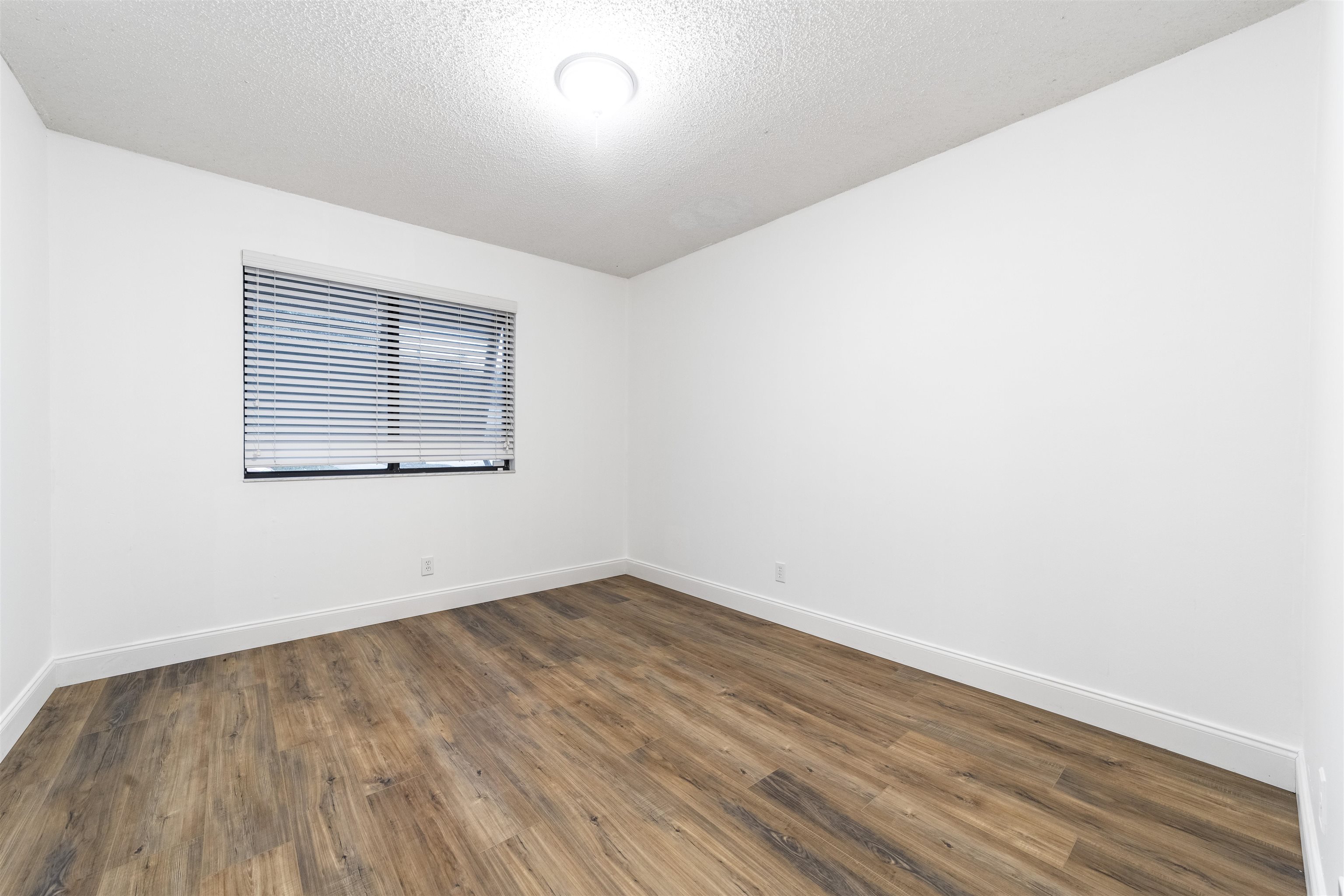 111 Lobelia Road St. Augustine, FL 32086 - Photo 36 of 46 an empty room with wooden floor and windows