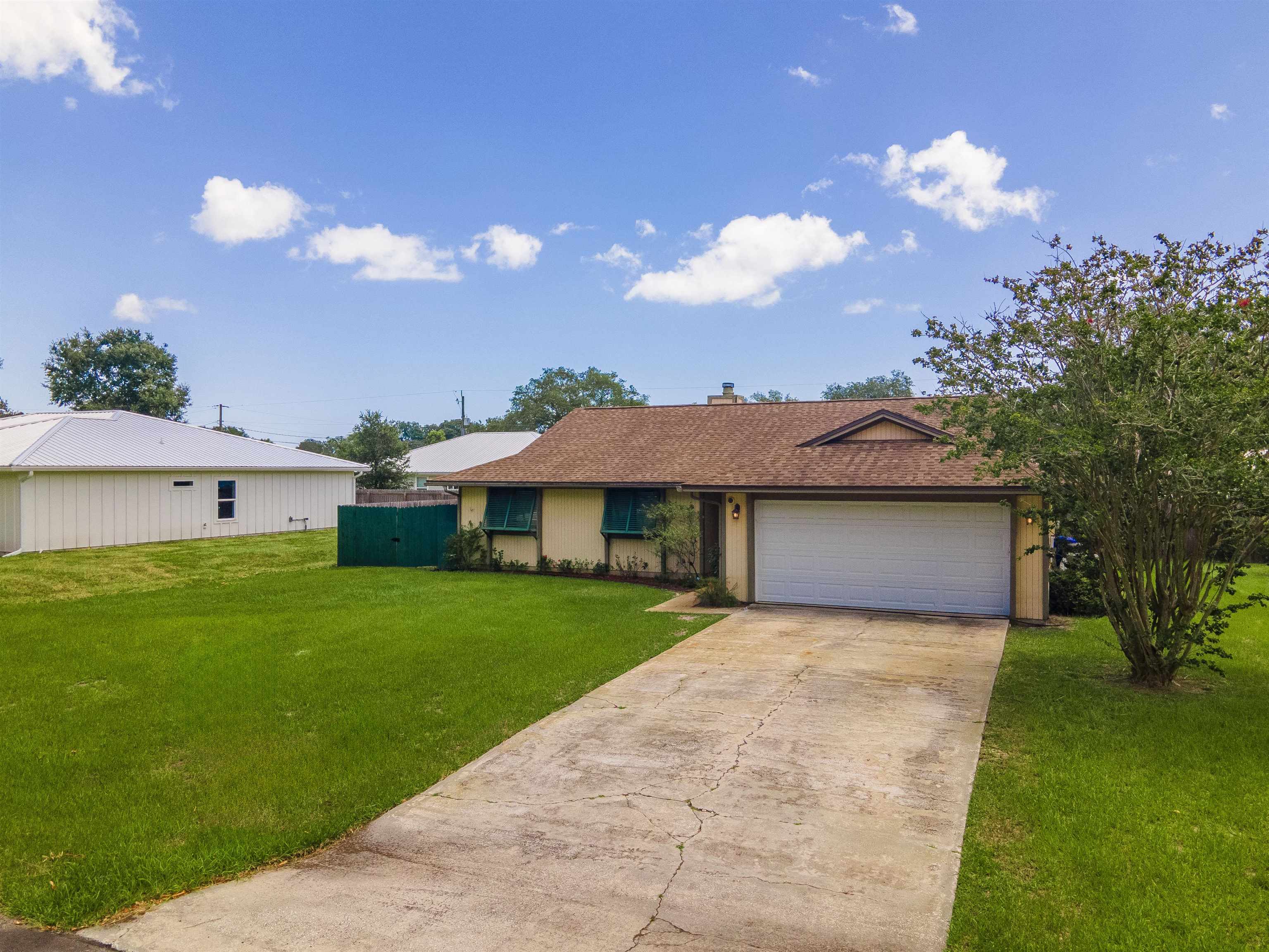 111 Lobelia Road St. Augustine, FL 32086 - Photo 46 of 46 a view of a house with a big yard and a large tree