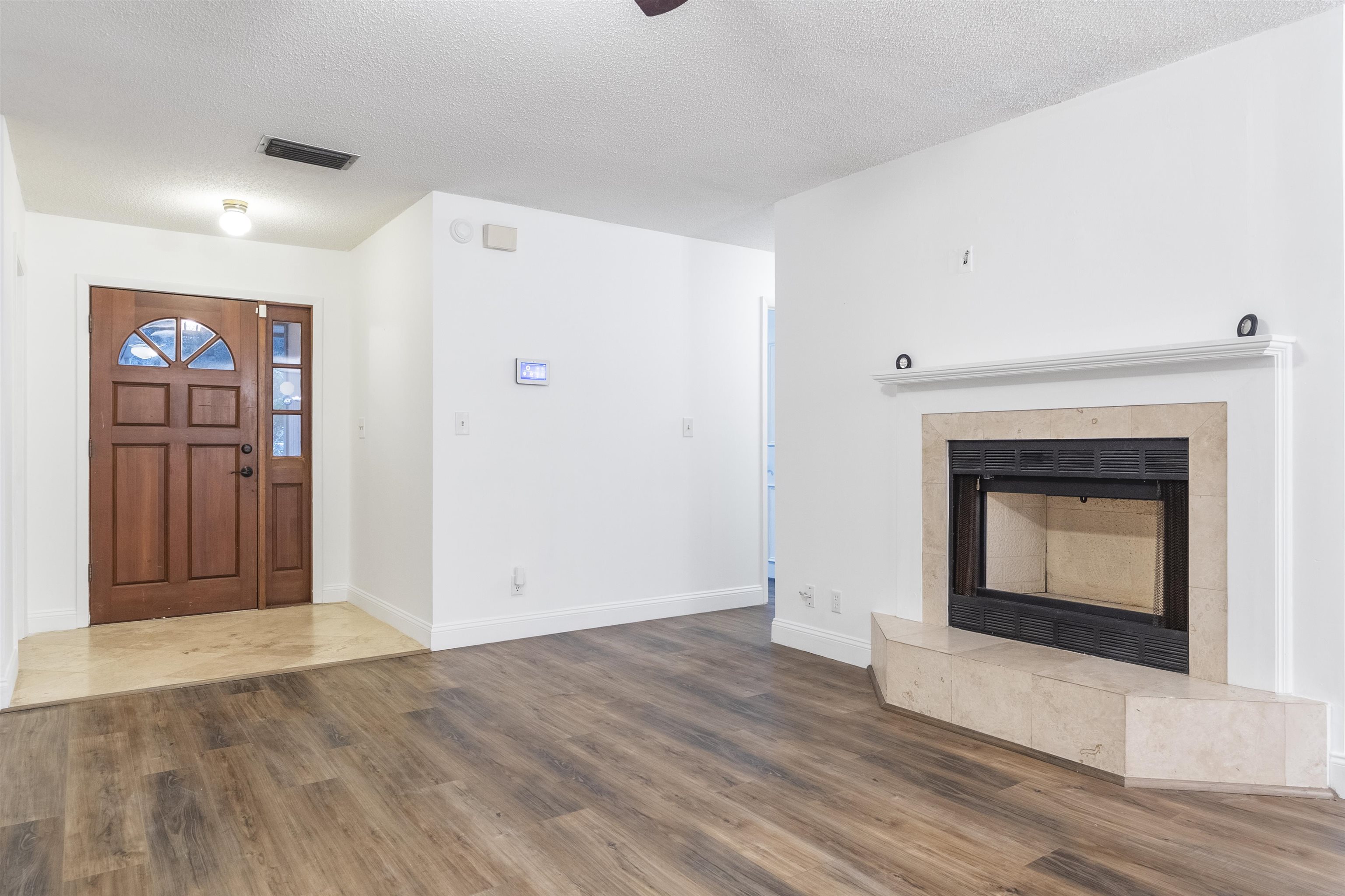 111 Lobelia Road St. Augustine, FL 32086 - Photo 6 of 46 a view of a livingroom with wooden floor and a fireplace