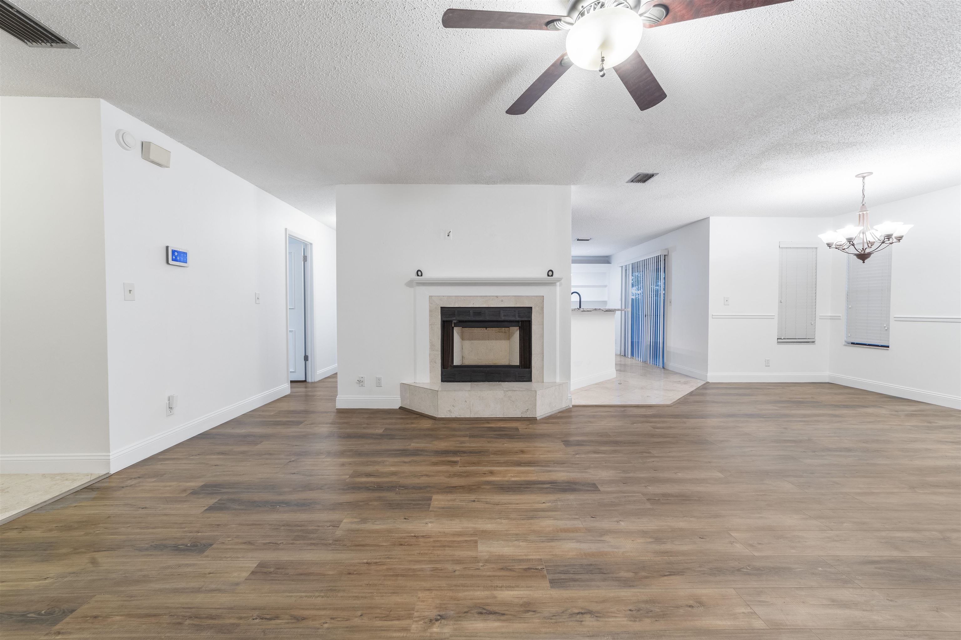 111 Lobelia Road St. Augustine, FL 32086 - Photo 10 of 46 a view of an empty room with a fireplace and a ceiling fan