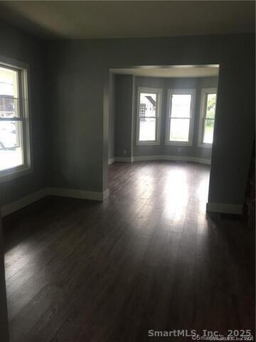 102 Lombard Street, Unit 1 New Haven, CT 06513 - Photo 5 of 7 an empty room with wooden floor and windows