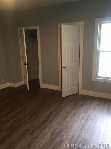 102 Lombard Street, Unit 1 New Haven, CT 06513 - Photo 6 of 7 an empty room with wooden floor and windows