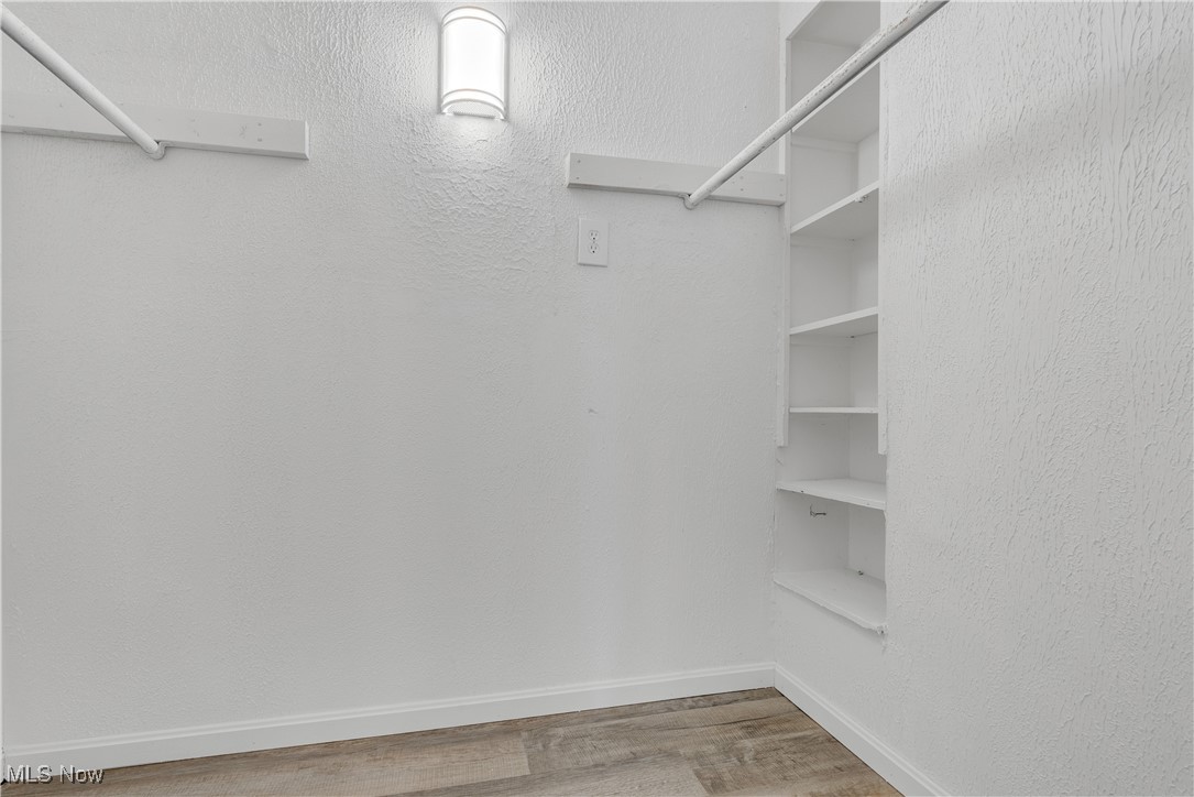 1893 Benjamin Road Madison, OH 44057 - Photo 14 of 23 Walk in closet with wood finished floors