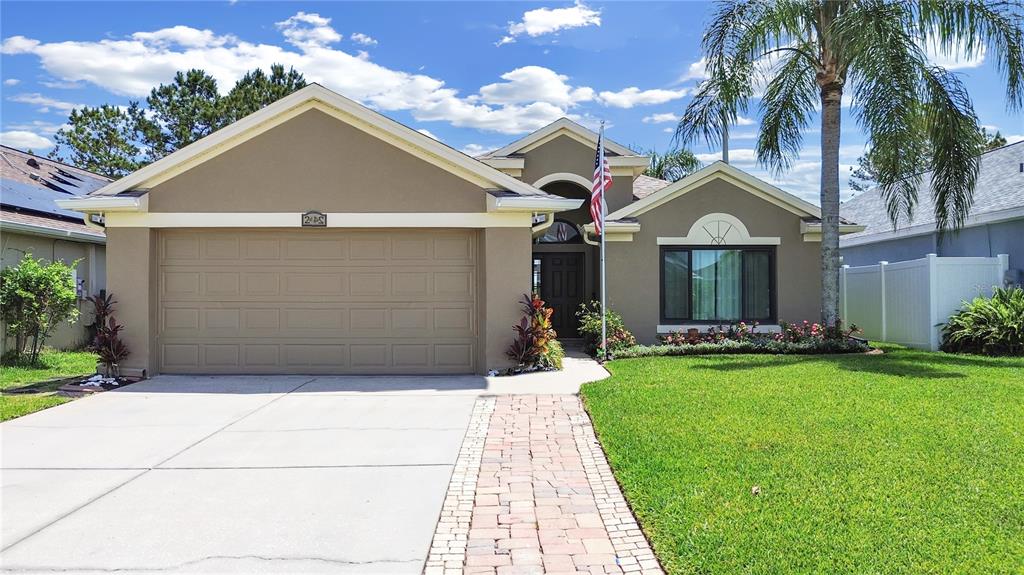a front view of a house with a yard and garage