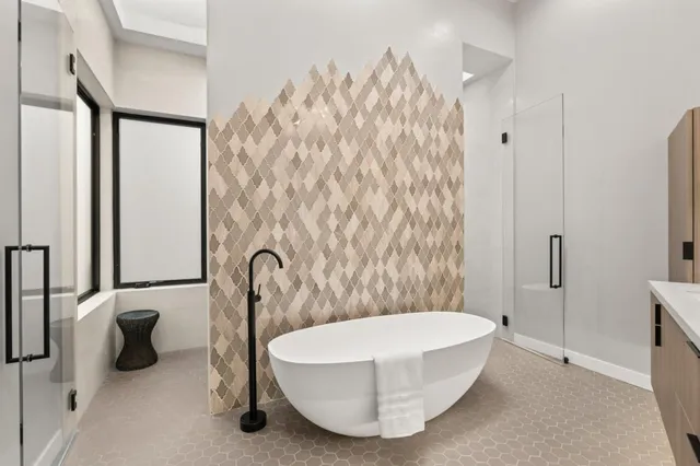 a en suite bathroom with a double vanity sink and a mirror