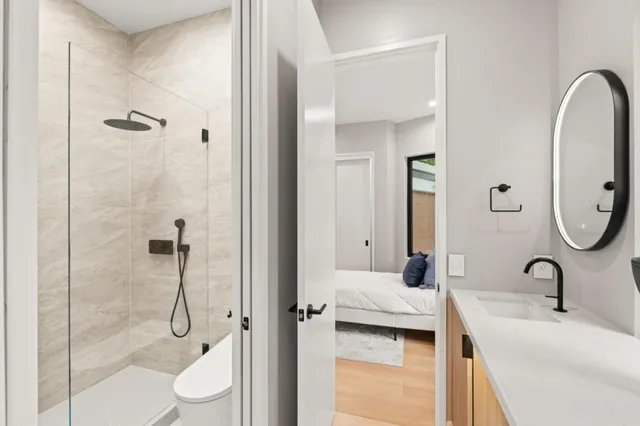 a bedroom with a bed and a large window