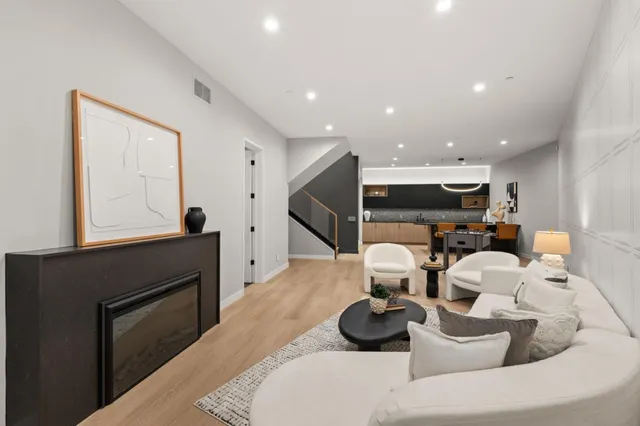 a kitchen with stainless steel appliances kitchen island granite countertop a table and chairs in it