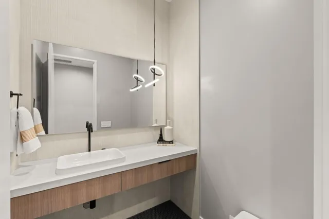 a bathroom with a sink mirror and shower
