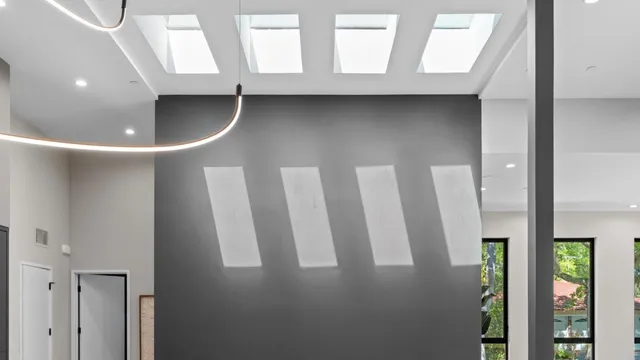 a view of room with a large window and wooden floor