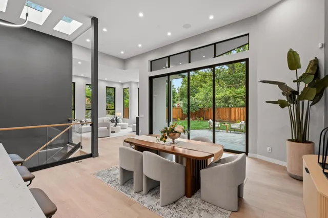 a kitchen with a table chairs refrigerator and microwave