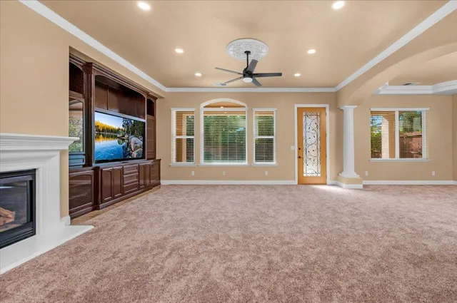 a view of an empty room with a fireplace and a window
