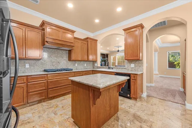 a bathroom with a granite countertop sink a toilet and a mirror