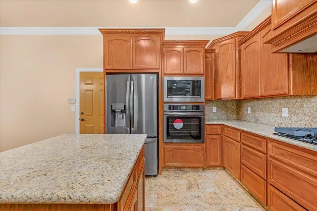 a bathroom with a granite countertop sink a large mirror and vanity