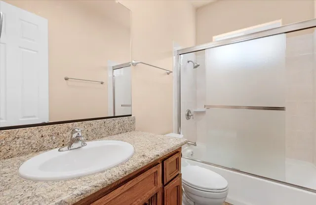 a view of a backyard with plants and a large tree
