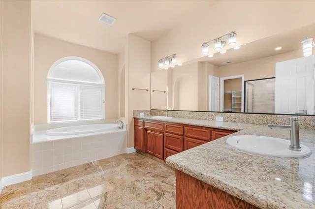 an aerial view of a house with a yard and sitting space