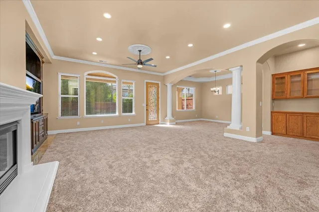 a view of an empty room with a fireplace and a window