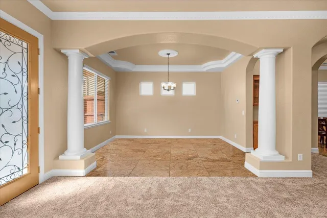 a view of an empty room with a fireplace and a window