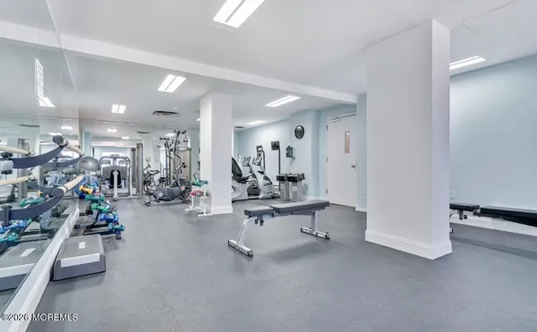 a living room with a rug and a table